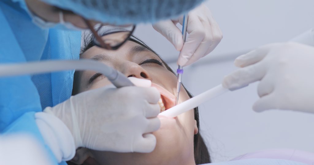 Dentist examines the patient teeth