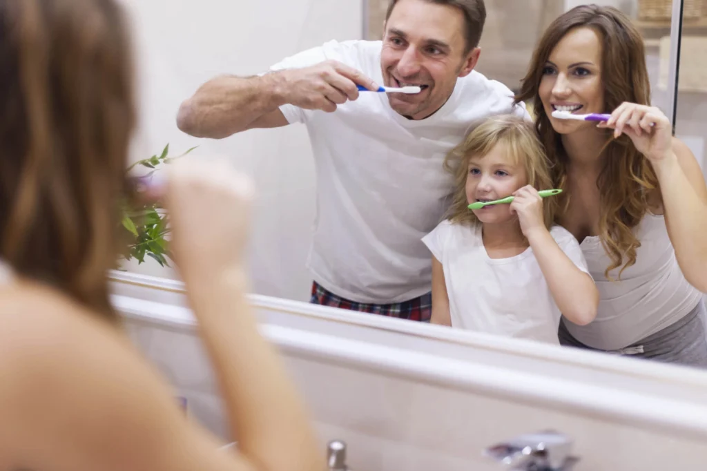 Family brushing teeth instucted by dr kafayi